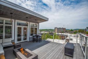 a balcony with a fireplace and a view of a city at Largest Rooftop w Firepit - Vaulted LUXE Penthouse in Knoxville