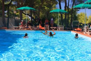 a group of people swimming in a swimming pool at Hotel Kyrie Isole Tremiti in San Domino