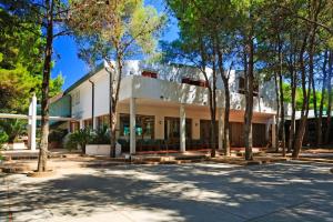 a white building with trees in front of it at Hotel Kyrie Isole Tremiti in San Domino
