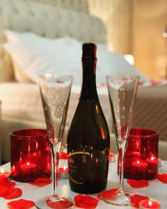 a bottle of wine on a table with two glasses at Hotel Arberia in Tirana +47 photos