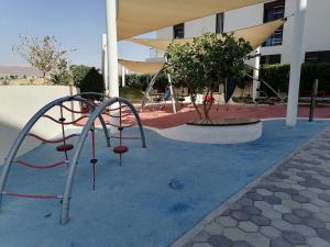 een speeltuin voor een gebouw bij Blue Diamond Ayla - Restricted to Family stays in Aqaba