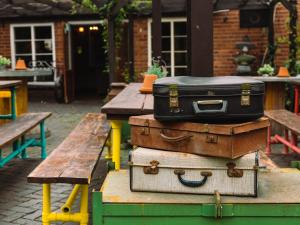 a stack of suitcases sitting on top of a table at The Old Crown in Birmingham