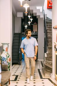 a man is walking down a hallway at RW BOUTIQUE HOTEL in Istanbul