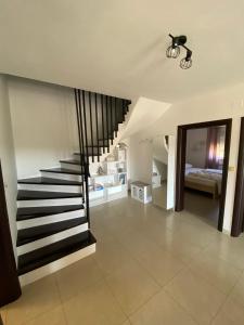 a hallway with a staircase in a house at Apartman Ana in Rab