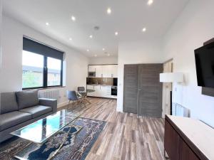 a living room with a couch and a table at Omega Inn in Milton Keynes