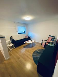 a living room with a couch and a table at Apartma KAMNITNK in Škofja Loka