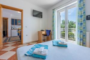 a room with a table with towels on it at Apartmani Jarić in Novi Vinodolski +93 photos