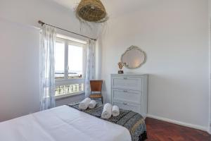 a bedroom with a bed with a dresser and a window at Charming TM Flat by the Ocean with a View in Cruz Quebrada