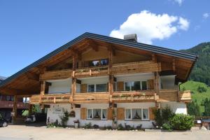 a large wooden building with a lot of windows at Alp-Chalet in Hirschegg