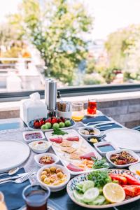 a table with many plates of food on it at RW BOUTIQUE HOTEL in Istanbul