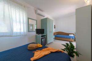 Postel nebo postele na pokoji v ubytování Albergo Villa A Mare
