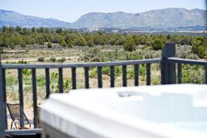 a balcony with a view of the mountains at Sunny Southwest Cottage in Mancos