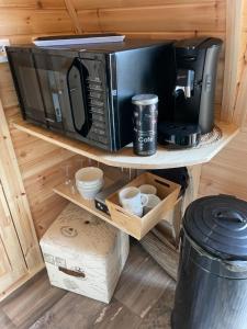 a microwave oven sitting on top of a shelf at Le charmant Pod du Parolais in Beauvoisin