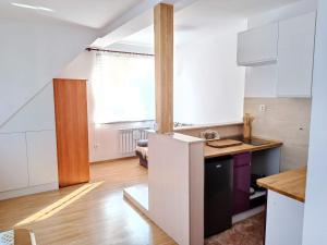 a kitchen with white cabinets and a counter top at Apartament w Świnoujściu in Świnoujście