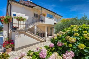 a house with flowers in front of it at Apartments Hortensia in Pula