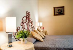 a bedroom with a bed with a iron head board at Cozy CENTRAL apartment in Florence - spectacular views of Duomo in Florence