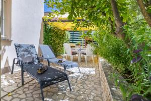 a patio with two chairs and a table at Apartments Hortensia in Pula
