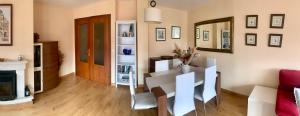 a living room with a table and a couch at El trocito de mar in Luanco