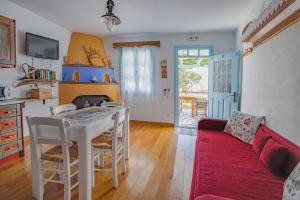 a living room with a table and a couch at Stella's traditional house. in Alonnisos