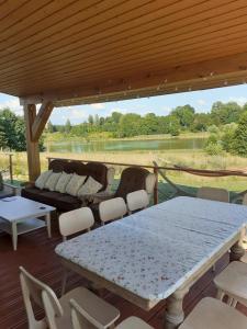 a patio with a table and chairs and a couch at Siedlisko Upałty in Giżycko