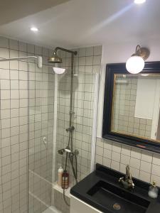 a bathroom with a shower and a sink and a mirror at Ruzafa Beach in Benidorm