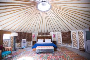a bedroom with a bed in a tent at Roomy Yurts, Gulmit Hunza in Gulmit