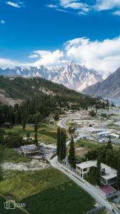 an aerial view of a town with mountains and a road at Roomy Yurts, Gulmit Hunza in Gulmit