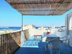 a table and chairs on a balcony with a view of the ocean at Appartamenti Iacono in Forio d'Ischia
