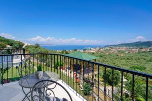 a balcony with a table and a view of the ocean at Villa Valia Calda in Limenas