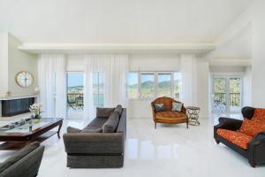 a living room with two couches and a table at Villa Valia Calda in Limenas