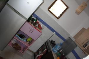 an overhead view of a kitchen with a pink refrigerator at Guesthouse Benardo in Sarandë