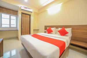 a bedroom with a large bed with red pillows at Hotel Morgan in Jaipur