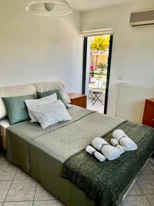 a bedroom with a large bed with towels on it at Thedreamlifehouse in Anavissos