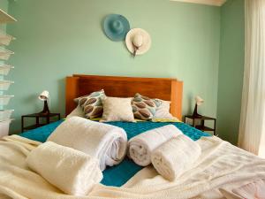 a bedroom with a bed with towels on it at Ocean view - Baleal beach house - Surf & Relax in Baleal