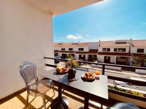 a balcony with a table and a view of a building at Ocean view - Baleal beach house - Surf & Relax in Baleal