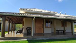 a house with a large deck in front of it at Sítio da Pedra in Cunha
