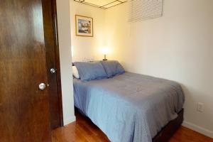 a bedroom with a bed with a lamp on it at Lake Den in Vassalboro