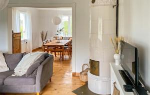 a living room with a couch and a table at Gorgeous Home In Lyrestad With Wifi in Lyrestad