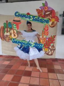a woman is standing in front of a sign at Cosmos Tatacoa Hotel in Villavieja