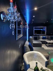 a living room with a couch and a chandelier at Suite avec piscine privée in Chelles