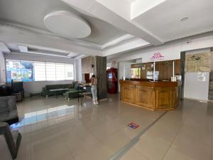 a lobby with a person standing in a room at Baskent Otel in Didim