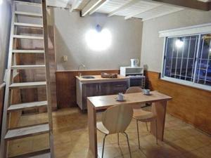 a kitchen with a table and chairs in a room at Complejo Pinamar Centro ,Departamentos en Pinamar in Pinamar