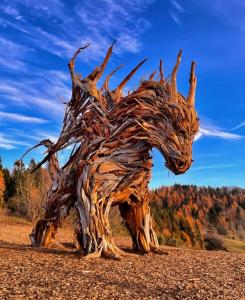 a statue of a horse made out of tree branches at Appartamento Paolo in Lavarone