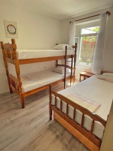 a bedroom with two bunk beds and a window at 1-bedroom apartment with 3 beds + private parking in Tivat