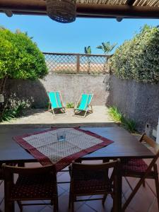 a table and chairs on a patio with a table at Casa Mandarino Forio Ischia in Ischia