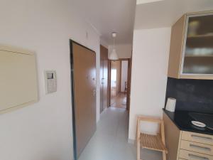 a room with a hallway with a door and a table at Alojamento Valverde in Nazaré +3 photos