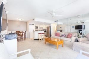 a living room with a couch and a table at Beachcomber 301, 2 Bedrooms, Near Mayo Clinic, Sleeps 4, Pool in Jacksonville Beach