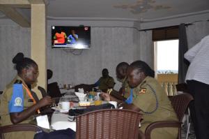 a group of people sitting at a table in a restaurant at Jusvero Motel in Jinja