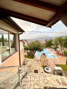 a view from the balcony of a house with a swimming pool at Exclusive Apartments Bistrik in Sarajevo