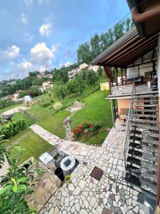 a backyard with a stone patio and a house at Exclusive Apartments Bistrik in Sarajevo